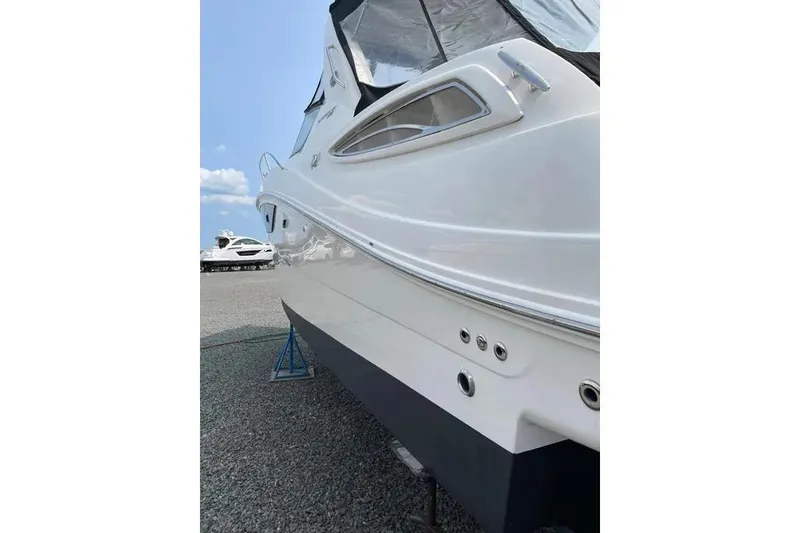 Slide: The Image of 2016 Sea Ray Sundancer 330 yacht on stands, side view, clear sky background. - 4