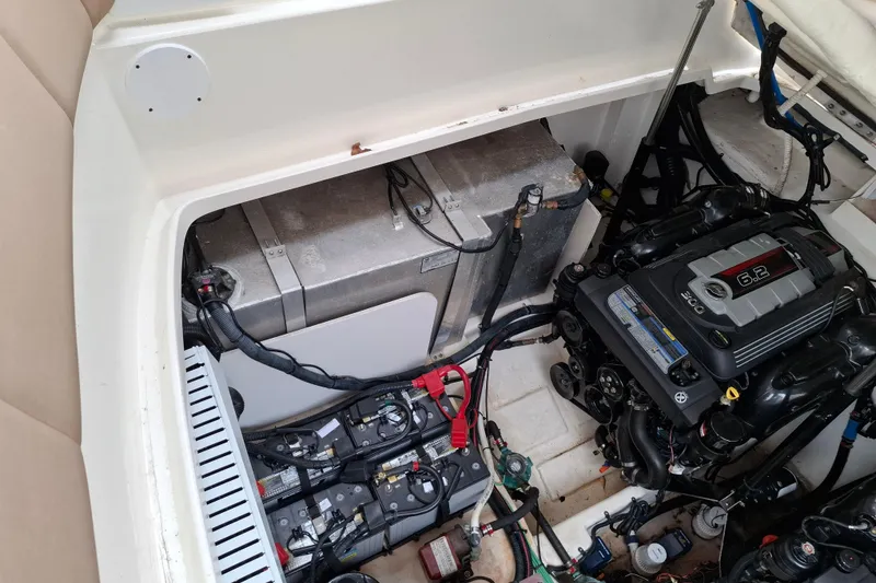 Slide: The Image of Engine compartment of a 2016 Sea Ray Sundancer 330 with visible batteries and wiring. - 23