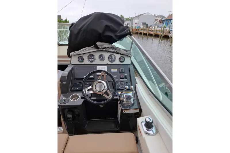 Slide: The Image of Helm of 2016 Sea Ray Sundancer 330 with steering wheel and control panel, dockside view. - 10