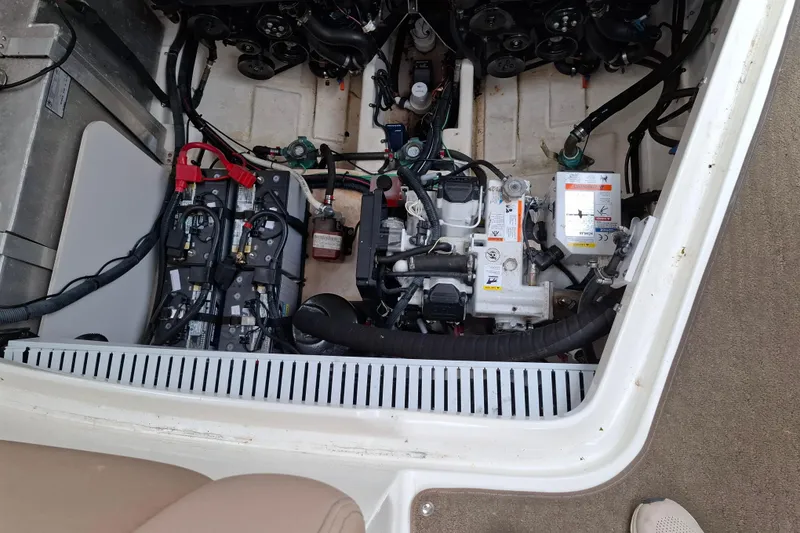 Slide: The Image of Engine compartment of a 2016 Sea Ray Sundancer 330, showcasing batteries and mechanical components. - 25