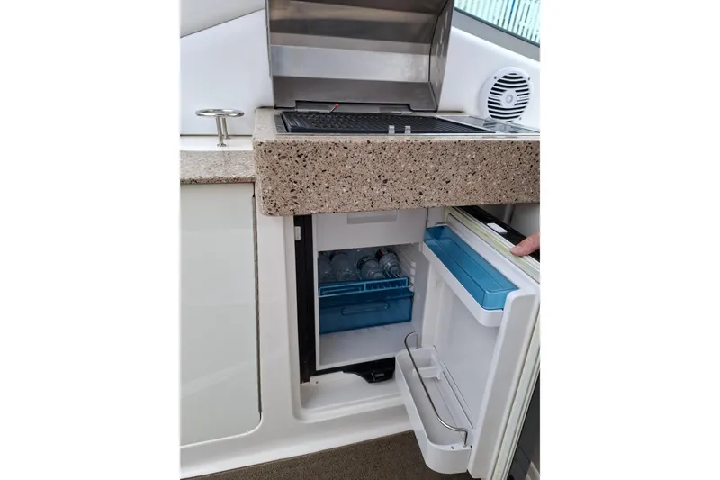 Slide: The Image of Sea Ray Sundancer 330 (2016) boat kitchenette with grill and mini fridge. - 12