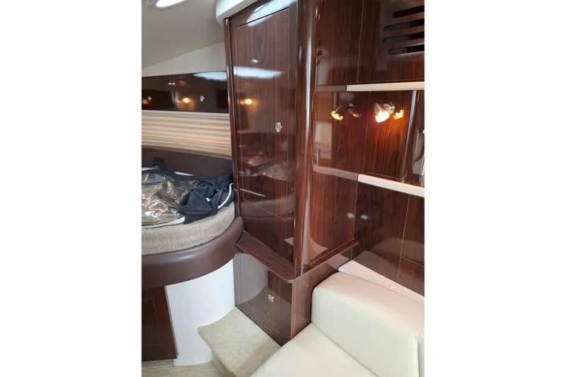 Slide: The Image of Interior of 2016 Sea Ray Sundancer 330 yacht with polished wood finish and cozy seating. - 14