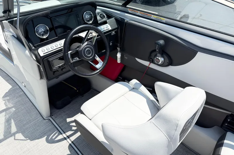 Slide: The Image of 2023 Crownline 240 SS boat interior with modern dashboard and steering wheel. - 7