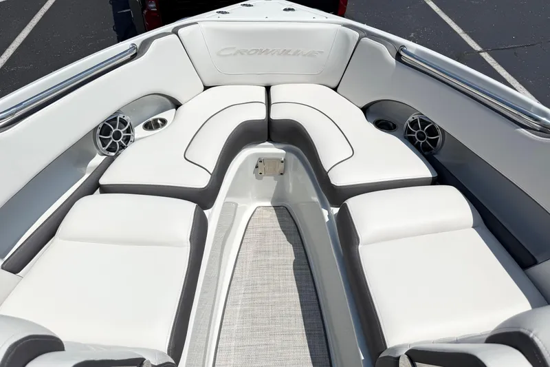 Slide: The Image of 2023 Crownline 240 SS boat interior with white cushioned seating and speaker system. - 4