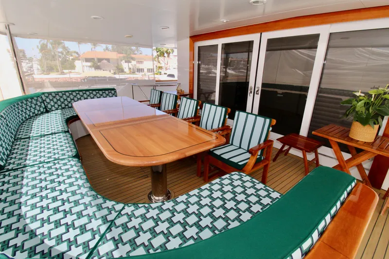 Slide: The Image of Luxurious 1988 Sterling 137 yacht deck with elegant seating and wooden table. - 23