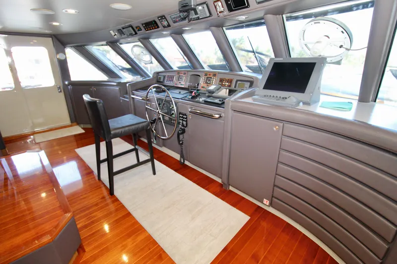 Slide: The Image of Luxurious 1988 Sterling 137 yacht helm with polished wood flooring and advanced navigation equipment. - 26