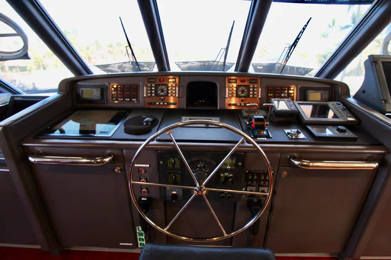Slide: The Image of 1988 Sterling 137 yacht helm with steering wheel and navigation controls. - 28