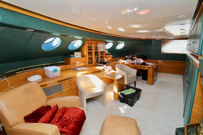 Slide: The Image of Luxurious yacht interior with leather seating, wooden cabinetry, and porthole windows, Sterling 137, 1988. - 20