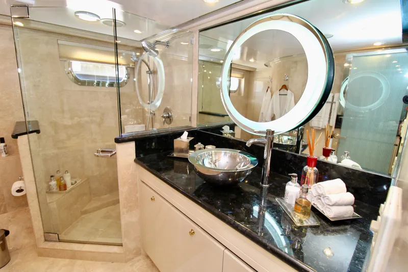 Slide: The Image of Luxurious yacht bathroom with modern fixtures, glass shower, and elegant vanity. Sterling 137, 1988 model. - 12