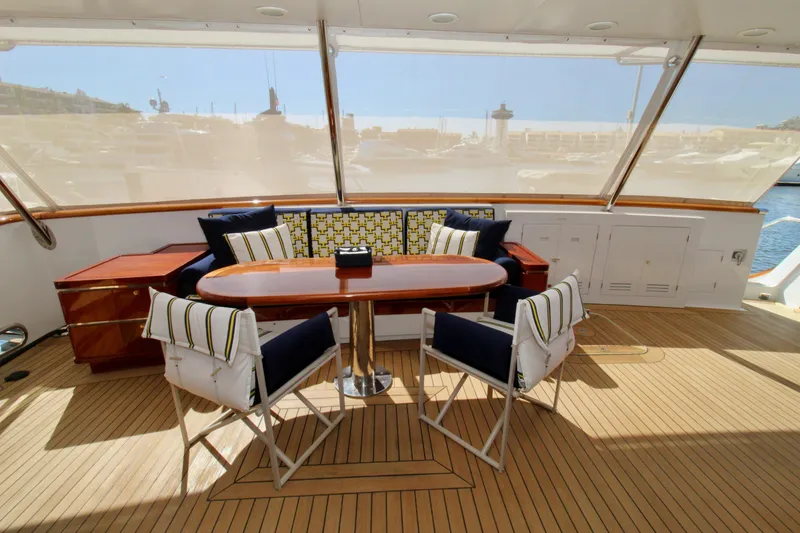 Slide: The Image of Luxurious 1988 Sterling 137 yacht deck with elegant seating and wooden table. - 2