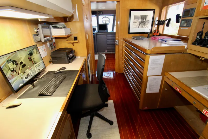 Slide: The Image of Office space inside a 1988 Sterling 137, featuring a desk, computer, and storage cabinets. - 29