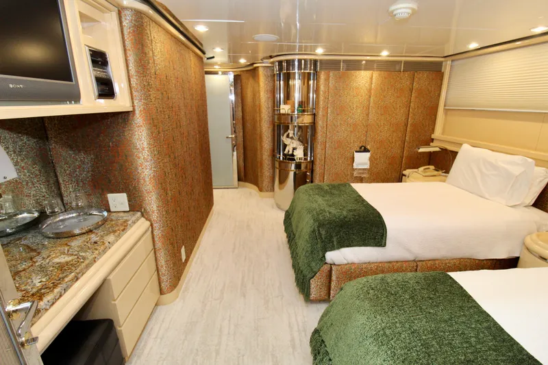 Slide: The Image of Luxurious 1988 Sterling 137 interior with twin beds, elegant decor, and modern amenities. - 18