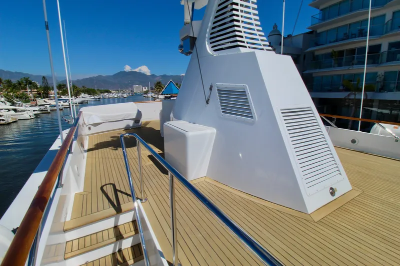Slide: The Image of 1988 Sterling 137 yacht deck with sleek design, docked in a scenic marina. - 22