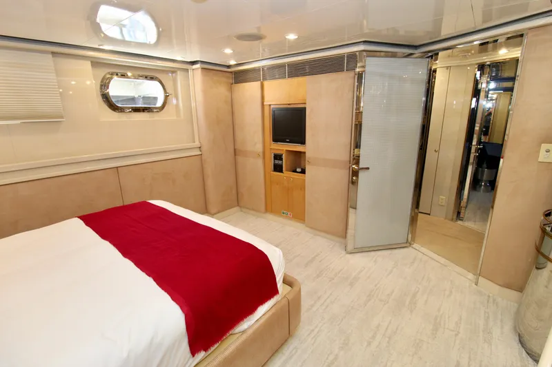 Slide: The Image of Luxurious 1988 Sterling 137 yacht bedroom with modern decor and red-accented bedding. - 15
