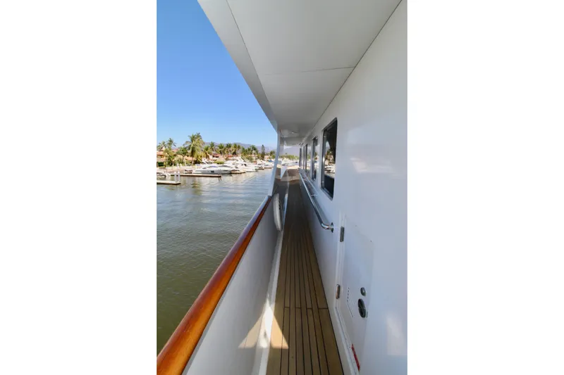 Slide: The Image of Side deck view of 1988 Sterling 137 yacht, overlooking marina with palm trees. - 21