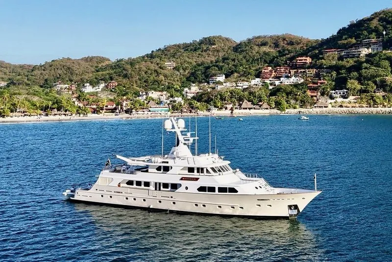 The Image of Luxurious 1988 Sterling 137 yacht cruising near scenic coastal landscape. - 0