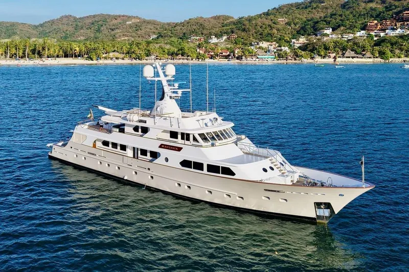 Slide: The Image of Luxurious 1988 Sterling 137 yacht cruising near a scenic coastline. - 32