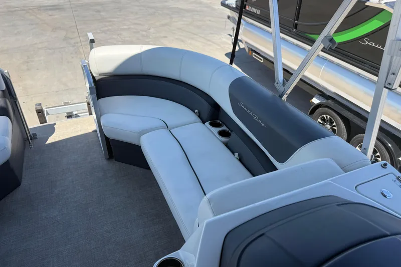 Slide: The Image of Luxurious seating on 2022 South Bay 224CR2 pontoon boat with cup holders and sleek design. - 9