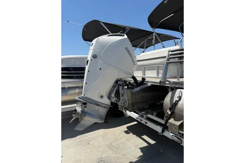 Slide: The Image of 2022 South Bay 224CR2 pontoon boat with Mercury outboard motor, docked under sunny skies. - 3