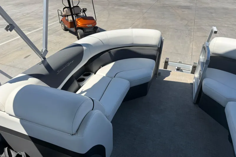 Slide: The Image of 2022 South Bay 224CR2 pontoon boat interior with plush seating and cup holders. - 10