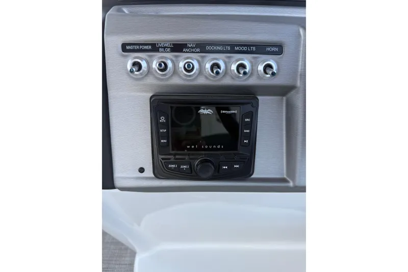 Slide: The Image of Control panel of 2022 South Bay 224CR2 boat with audio system and switches. - 13