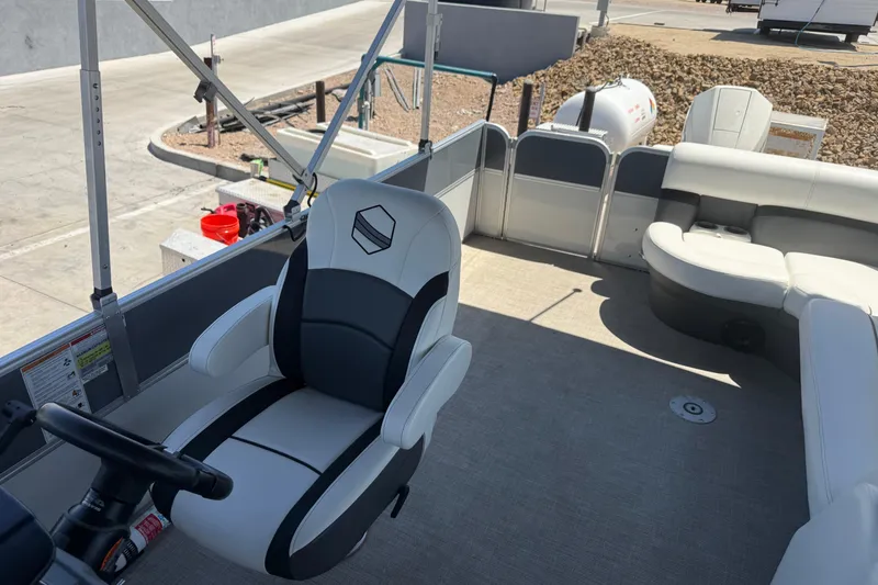 Slide: The Image of 2022 South Bay 224CR2 pontoon boat interior with captain's chair and seating area. - 11