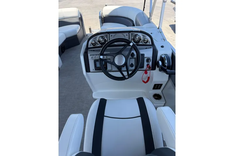 Slide: The Image of 2022 South Bay 224CR2 boat interior with steering wheel and control panel. - 12
