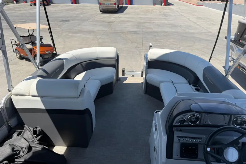 Slide: The Image of 2022 South Bay 224CR2 pontoon boat interior with plush seating and modern dashboard. - 8