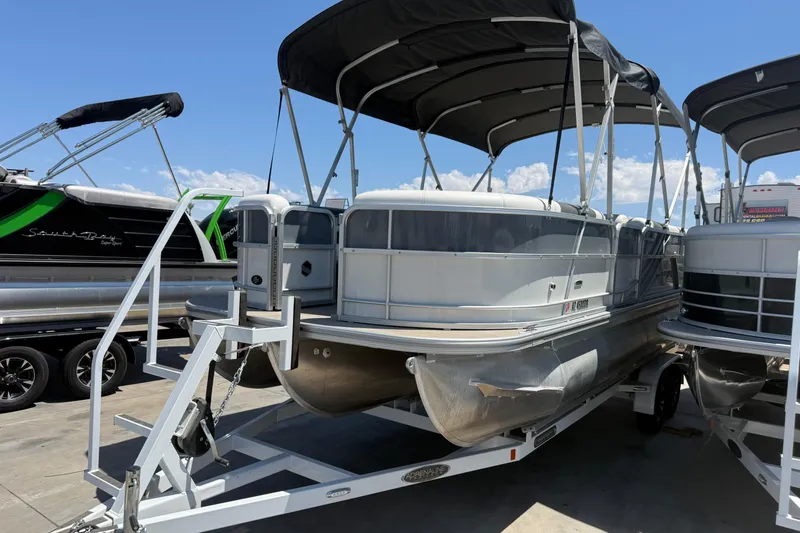 Slide: The Image of 2022 South Bay 224CR2 pontoon boat on trailer under blue sky. - 4