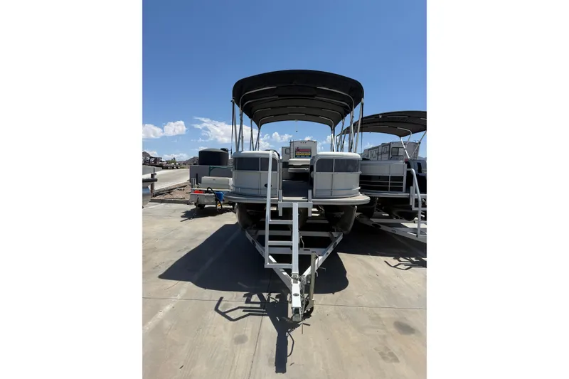 Slide: The Image of 2022 South Bay 224CR2 pontoon boat on trailer under clear blue sky. - 5