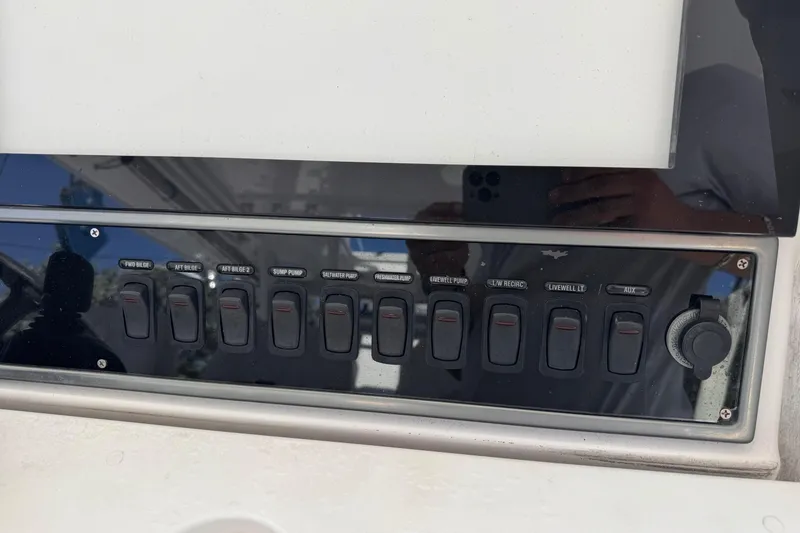 Slide: The Image of Control panel of a 2016 Everglades 435 Center Console boat with labeled switches. - 15