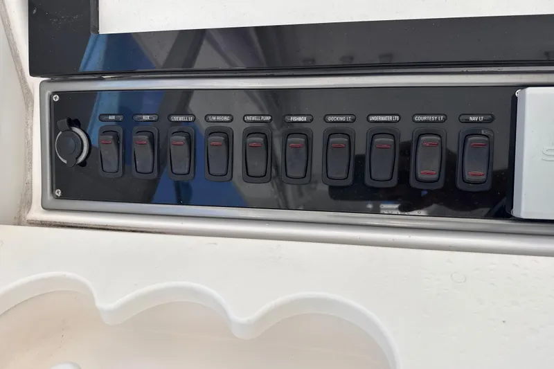 Slide: The Image of Control panel of a 2016 Everglades 435 Center Console boat with labeled switches. - 16