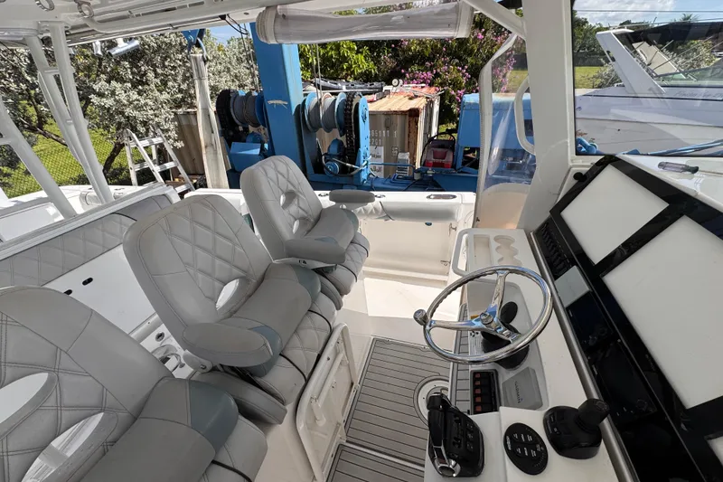 Slide: The Image of Interior of a 2016 Everglades 435 Center Console boat with modern seating and controls. - 14