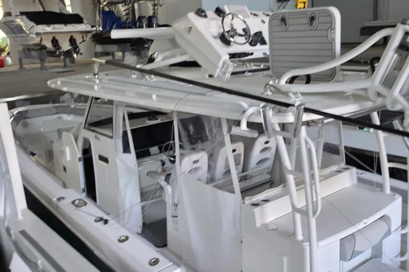 Slide: The Image of 2016 Everglades 435 Center Console boat in a showroom, showcasing sleek design and advanced features. - 7
