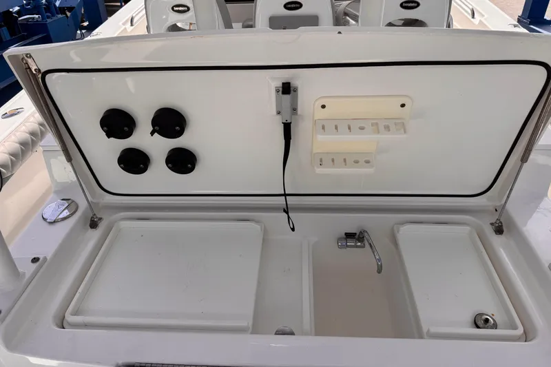 Slide: The Image of 2016 Everglades 435 Center Console boat with open storage compartment and sink. - 10