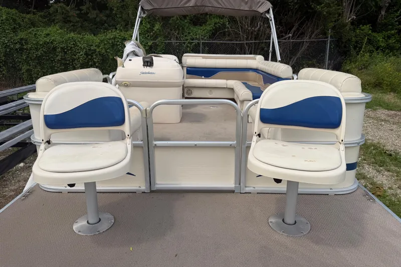 Slide: The Image of 2004 Sweetwater Challenger 200 RE-4 Gate pontoon boat with blue and white seating. - 6