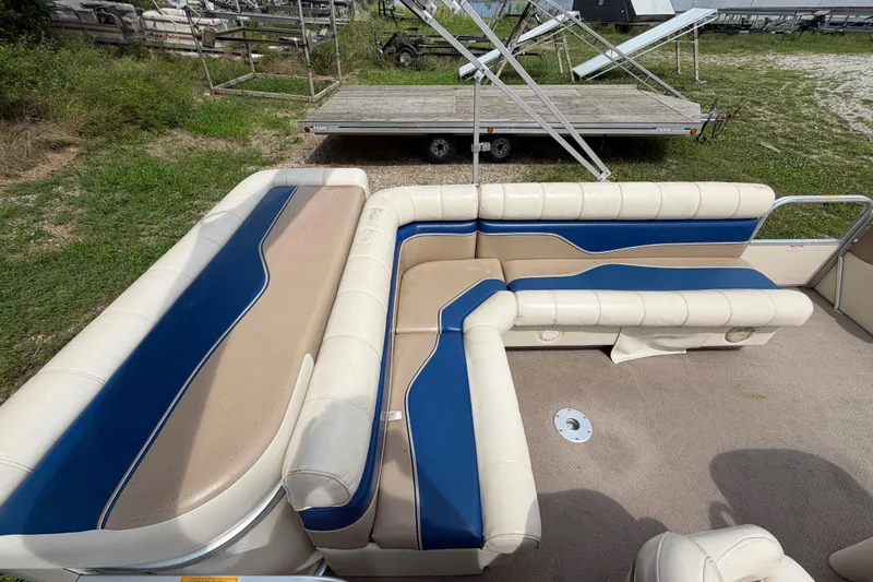 Slide: The Image of 2004 Sweetwater Challenger 200 RE-4 Gate pontoon boat interior with blue and beige seating. - 14