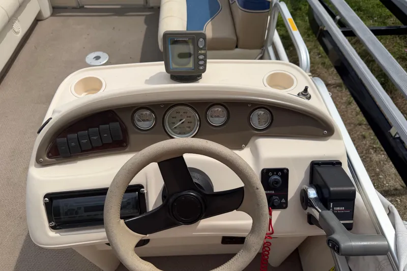 Slide: The Image of 2004 Sweetwater Challenger 200 RE-4 Gate boat dashboard with steering wheel and controls. - 15