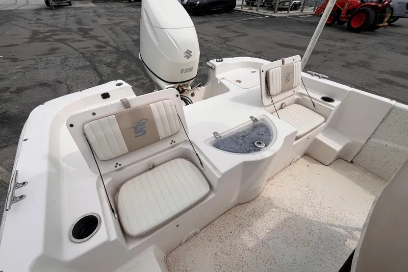 Slide: The Image of 2018 Carolina Skiff 198 DLV boat interior with seating and Suzuki 115 outboard motor. - 11