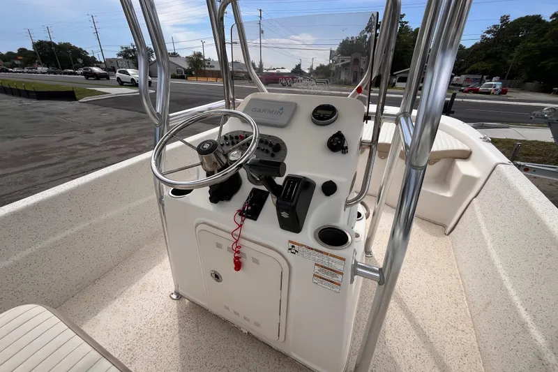 Slide: The Image of 2018 Carolina Skiff 198 DLV boat console with steering wheel and Garmin navigation system. - 8