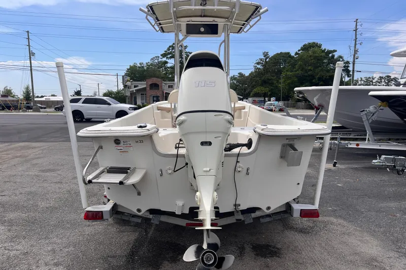 Slide: The Image of 2018 Carolina Skiff 198 DLV boat with outboard motor, parked on a trailer. - 4