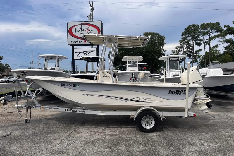 The Image of 2018 Carolina Skiff 198 DLV boat on trailer at dealership, side view. - 1