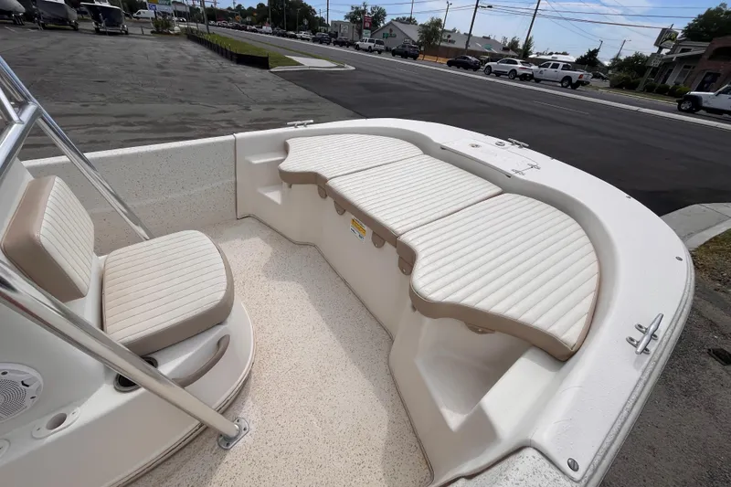 Slide: The Image of 2018 Carolina Skiff 198 DLV boat interior with cushioned seating and open deck view. - 12