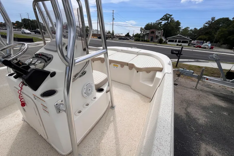 Slide: The Image of 2018 Carolina Skiff 198 DLV boat interior with console and seating, parked on a trailer. - 10