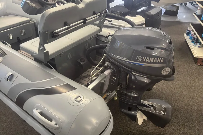 Slide: The Image of 2026 Highfield Classic 310 FCT with Yamaha outboard motor in showroom display. - 2