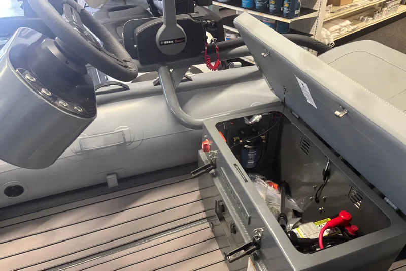 Slide: The Image of 2026 Highfield Classic 310 FCT boat interior with open storage compartment and steering wheel. - 5