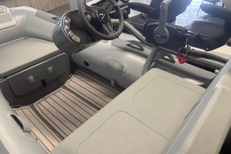 Slide: The Image of 2026 Highfield Classic 310 FCT boat interior with steering wheel and seating. - 3