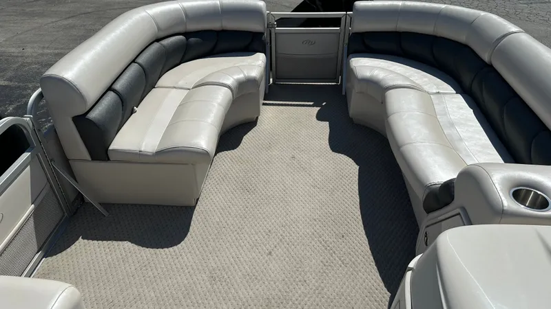 Slide: The Image of The image shows the spacious, cushioned seating area of a 2008 Manitou Legacy pontoon boat. - 16