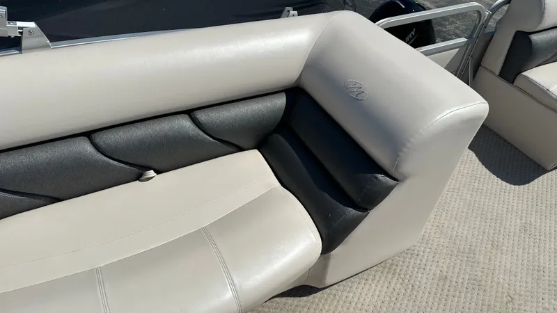 Slide: The Image of The image shows the cushioned seating of a 2008 Manitou Legacy pontoon boat. - 10