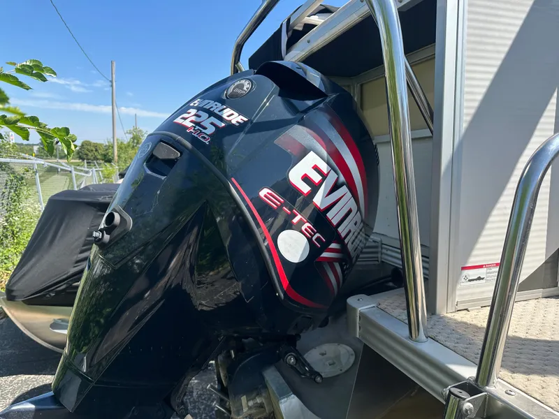 Slide: The Image of An Evinrude E-TEC outboard motor is mounted on a 2008 Manitou Legacy boat. - 2